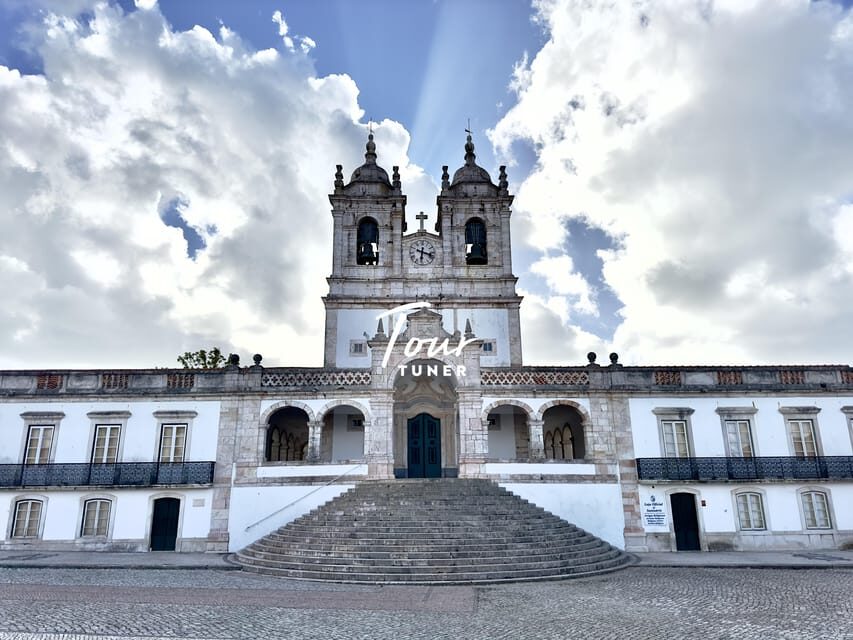 From Lisbon: Fátima, Batalha, Nazaré, & Óbidos. Private Tour - Nazaré cliff views, surf legend, and the women’s seven-skirt tradition
