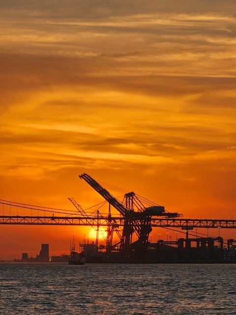 Lisbon: Private Sailboat Tour on the Tagus at Sunset - The Sail-Photo Moment: Opening the Black Sails and Passing Under the Bridge